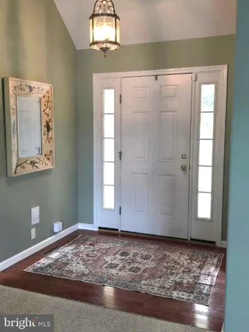 an empty room with windows and fireplace