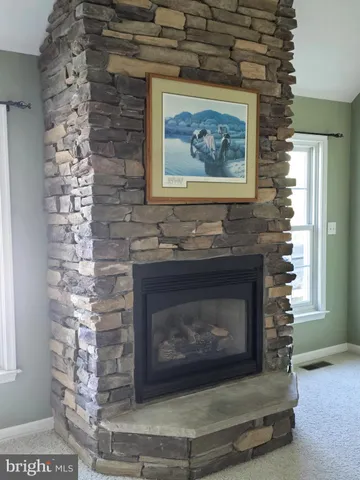 a stone fireplace with a clock on it