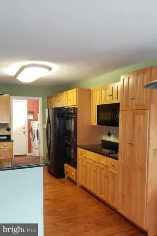 a kitchen with stainless steel appliances a refrigerator and a stove top oven
