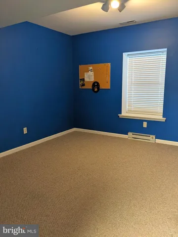 a view of an empty room with closet area