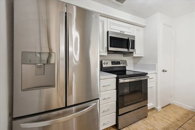 a kitchen that has a sink and a stove top oven
