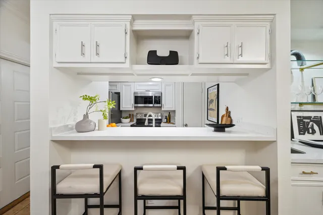 a kitchen with stainless steel appliances a refrigerator stove and microwave