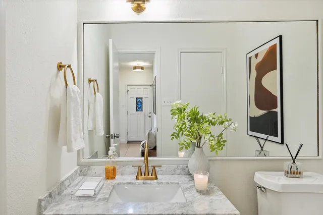 a kitchen with stainless steel appliances a table chairs and cabinets
