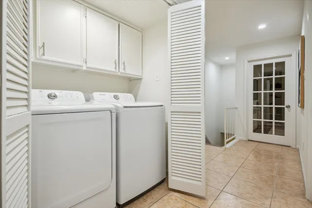 a view of washer and dryer with white cabinet