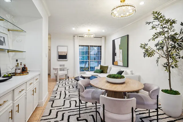 a view of a dining room with furniture and a potted plant