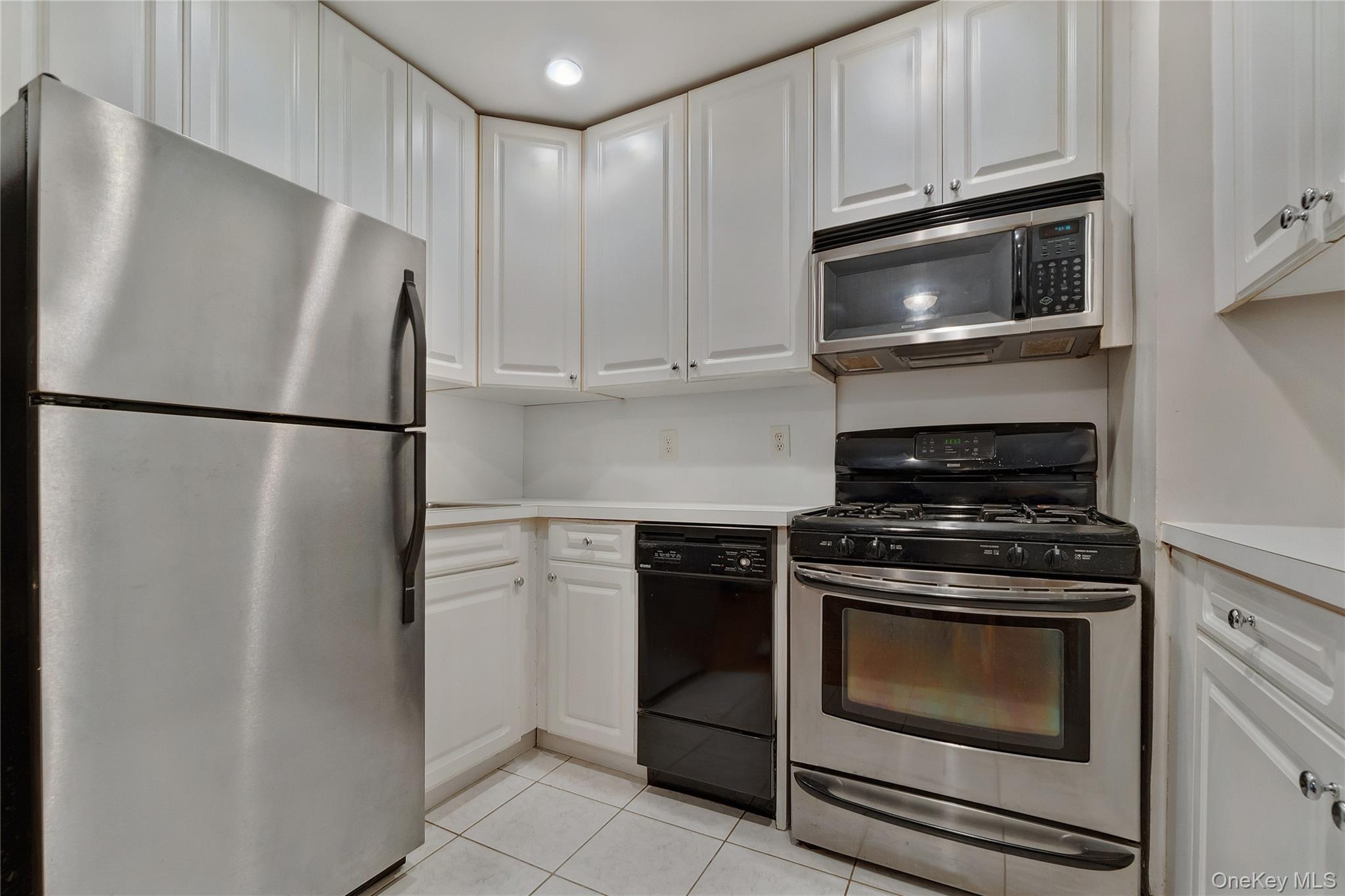 133 Beach 120th Street, Unit 2C Queens, NY 11694 - Photo 4 of 13 a kitchen with a stove microwave and refrigerator