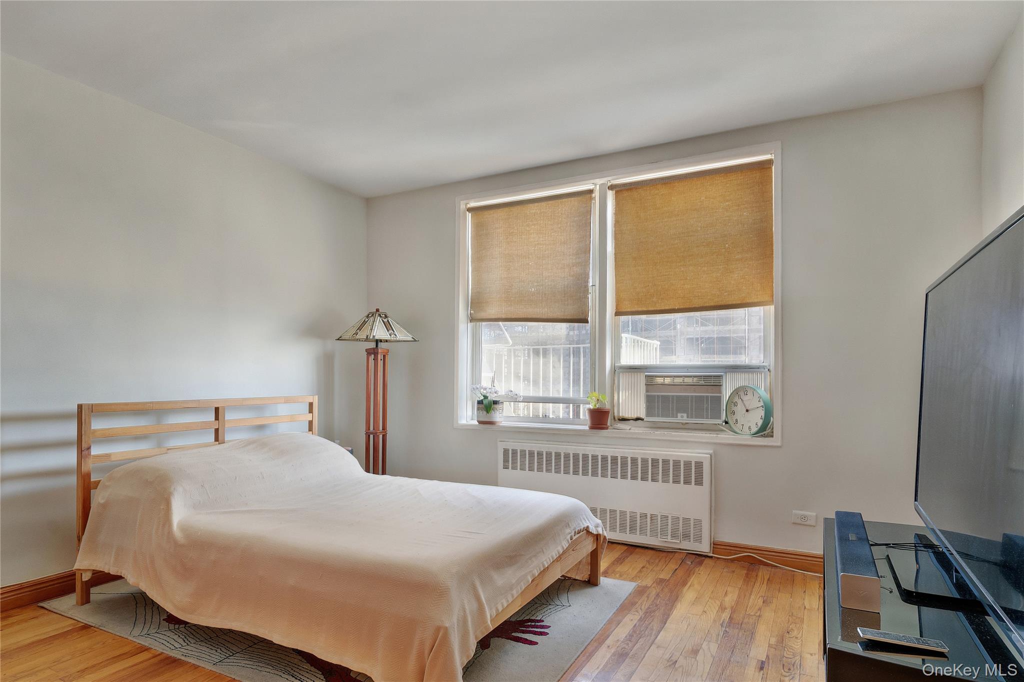 133 Beach 120th Street, Unit 2C Queens, NY 11694 - Photo 9 of 13 a bedroom with a bed and a window
