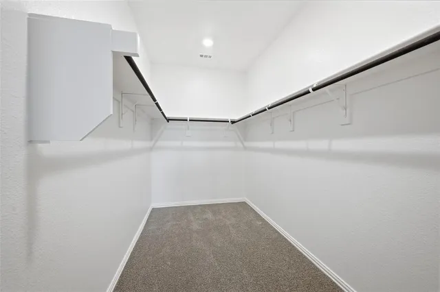 a view of a house with a backyard and wooden fence