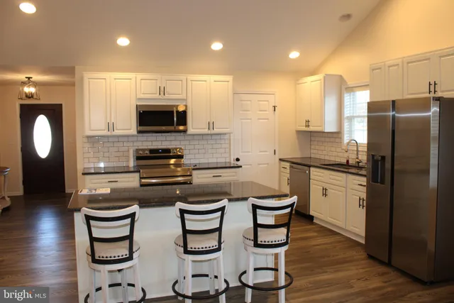 a view of a kitchen with granite countertop cabinets