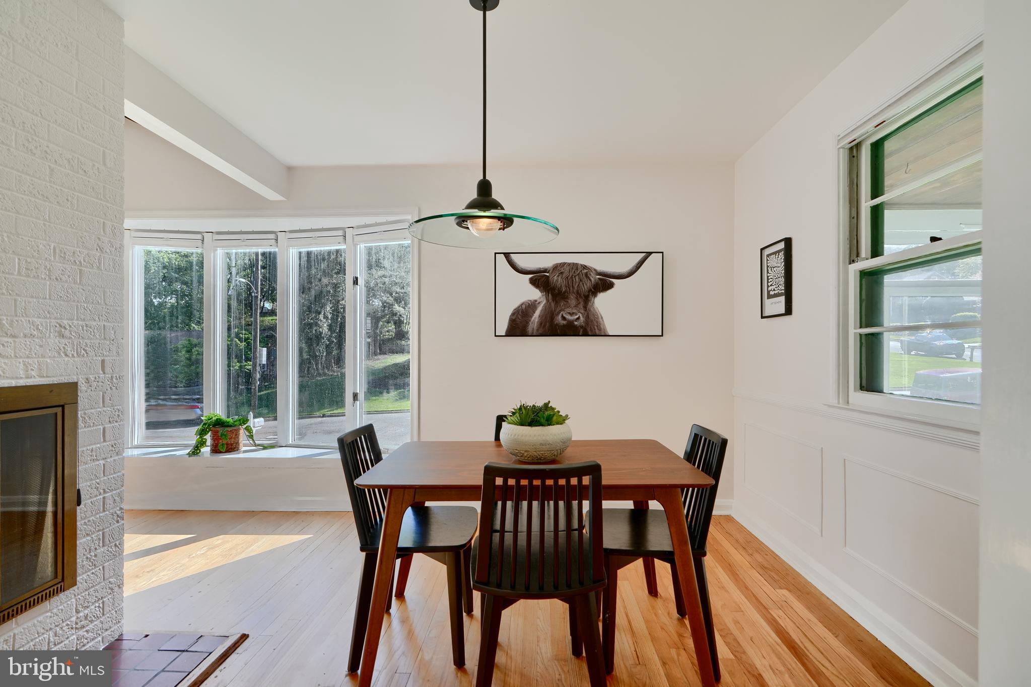 1316 Glendale Road Baltimore, MD 21239 - Photo 11 of 37 a dining room with furniture a chandelier and wooden floor