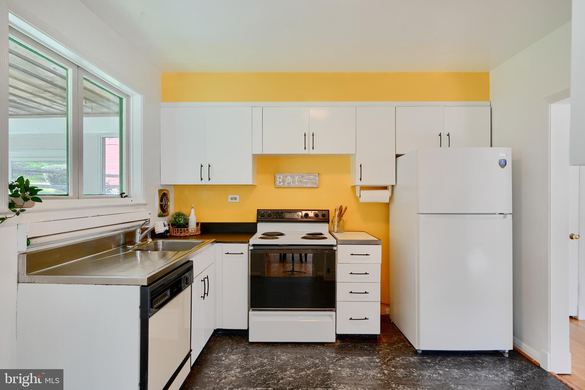 1316 Glendale Road Baltimore, MD 21239 - Photo 12 of 37 a kitchen with a stove a sink and a refrigerator