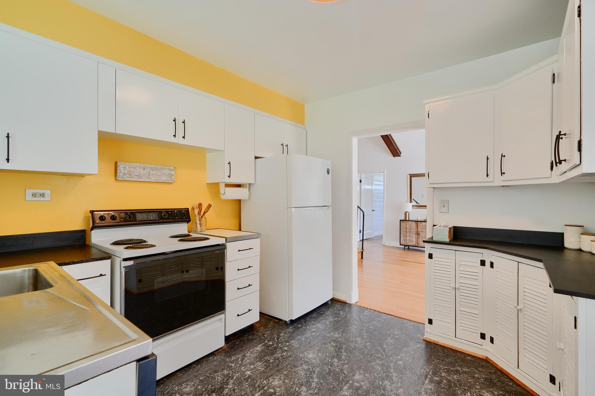 1316 Glendale Road Baltimore, MD 21239 - Photo 13 of 37 a kitchen with white cabinets and white appliances