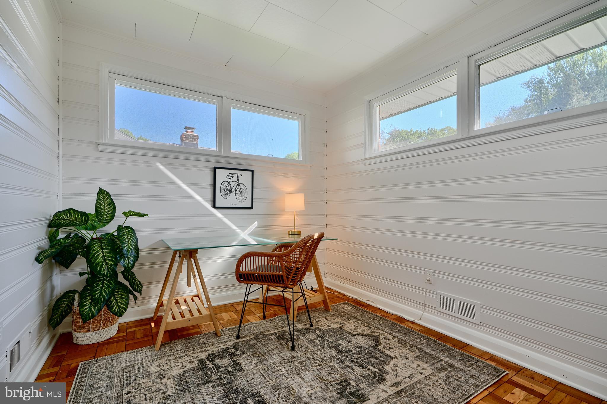 1316 Glendale Road Baltimore, MD 21239 - Photo 16 of 37 a view of a workspace room with wooden floor and chair