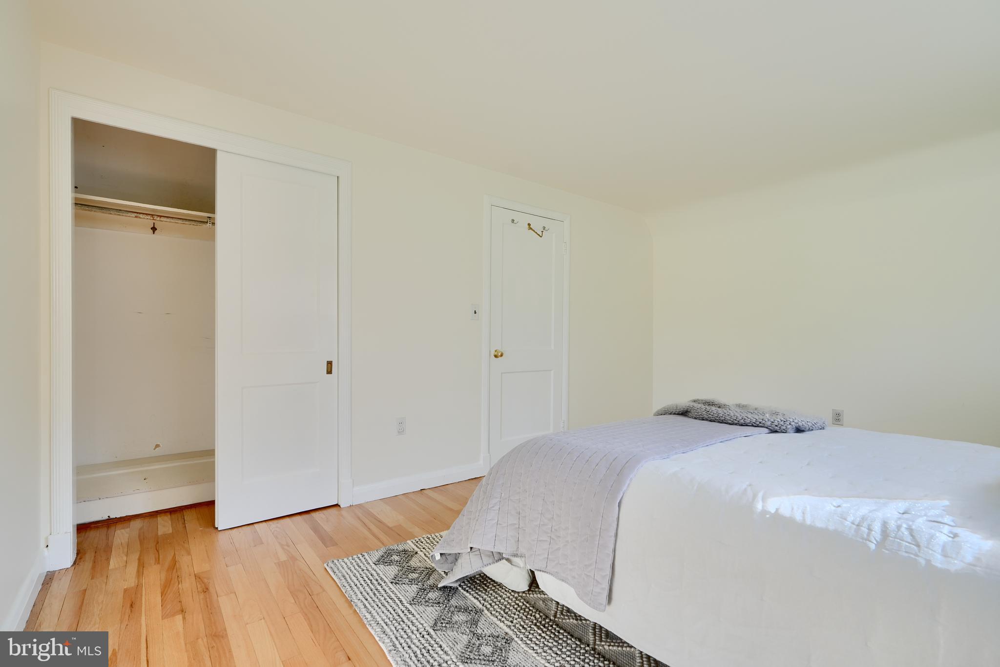 1316 Glendale Road Baltimore, MD 21239 - Photo 23 of 37 a bedroom with a bed and a wooden floor