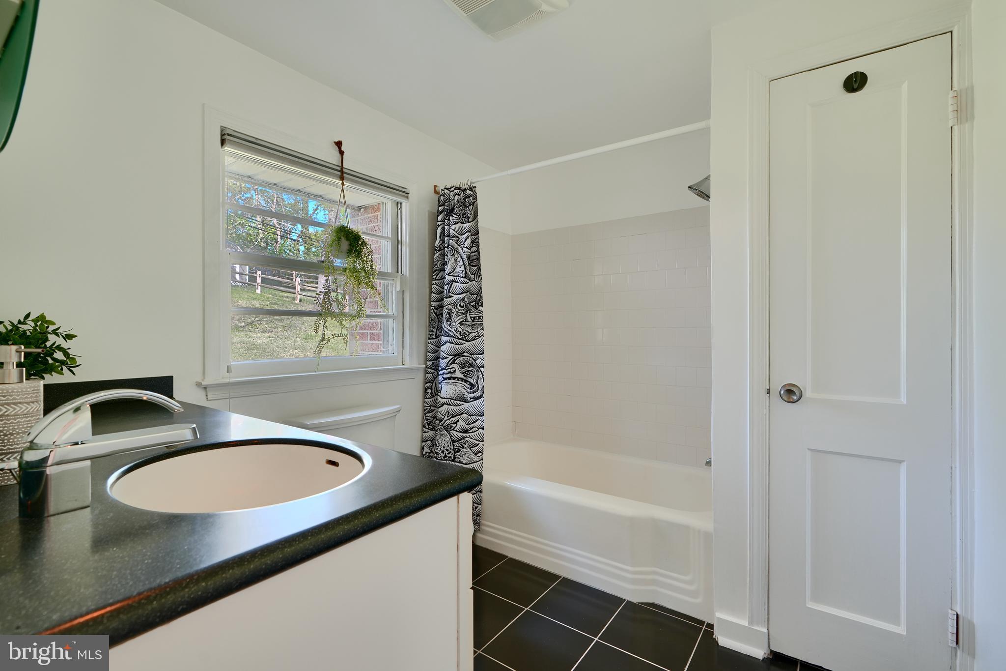 1316 Glendale Road Baltimore, MD 21239 - Photo 25 of 37 a bathroom with a granite countertop sink and a mirror