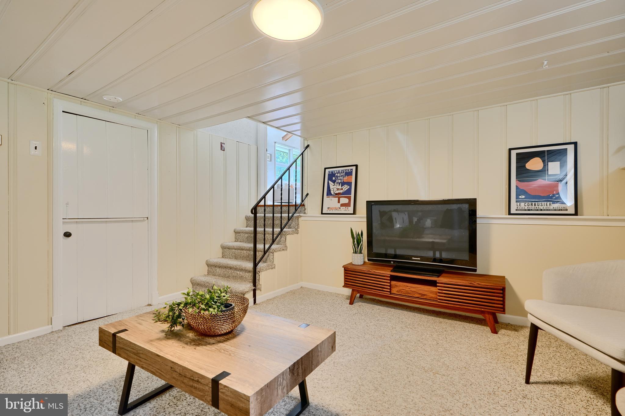 1316 Glendale Road Baltimore, MD 21239 - Photo 32 of 37 a living room with furniture and a flat screen tv