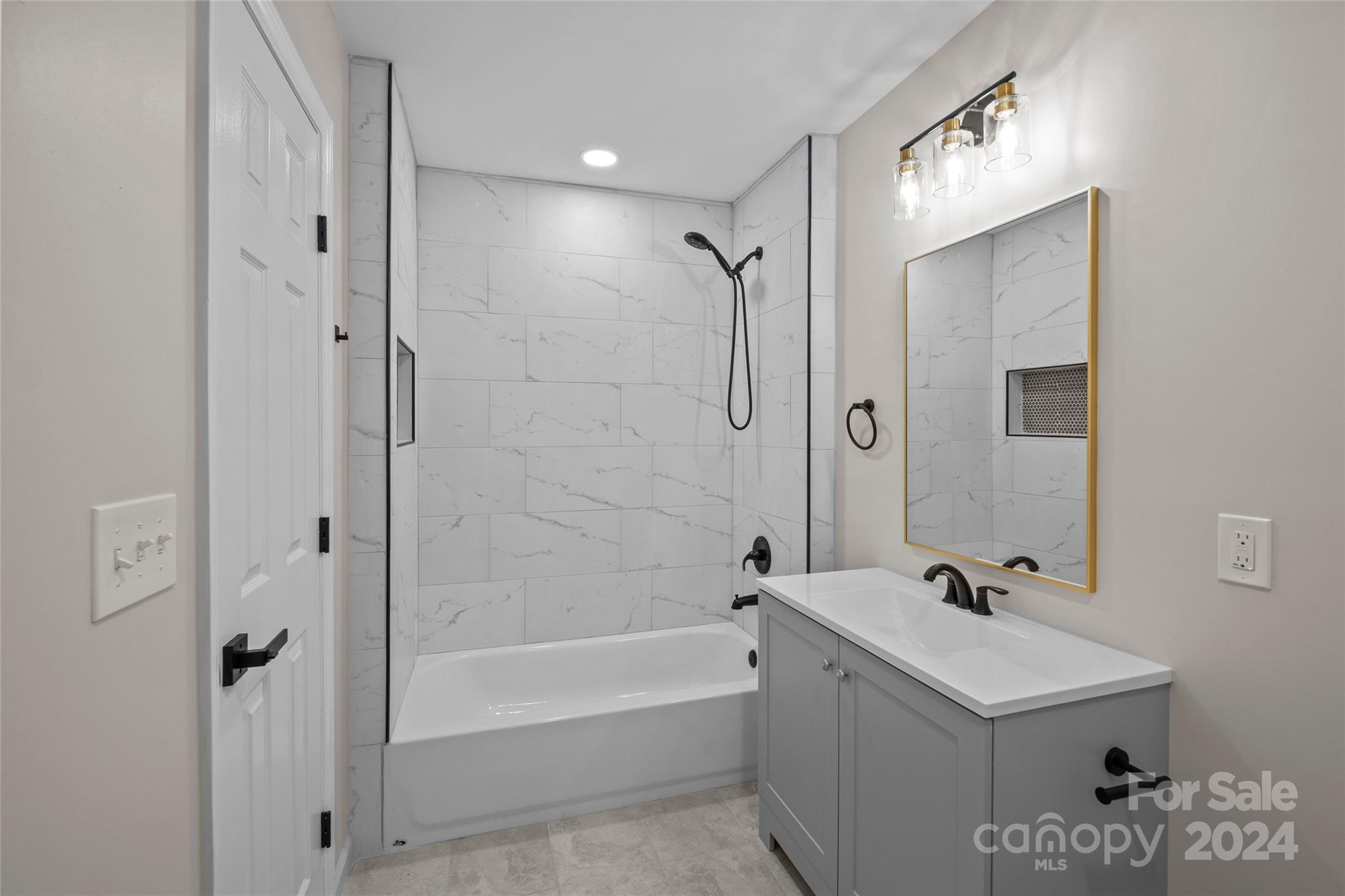 5808 Woody Grove Road Indian Trail, NC 28079 - Photo 15 of 30 a bathroom with a bathtub a shower a sink and a mirror