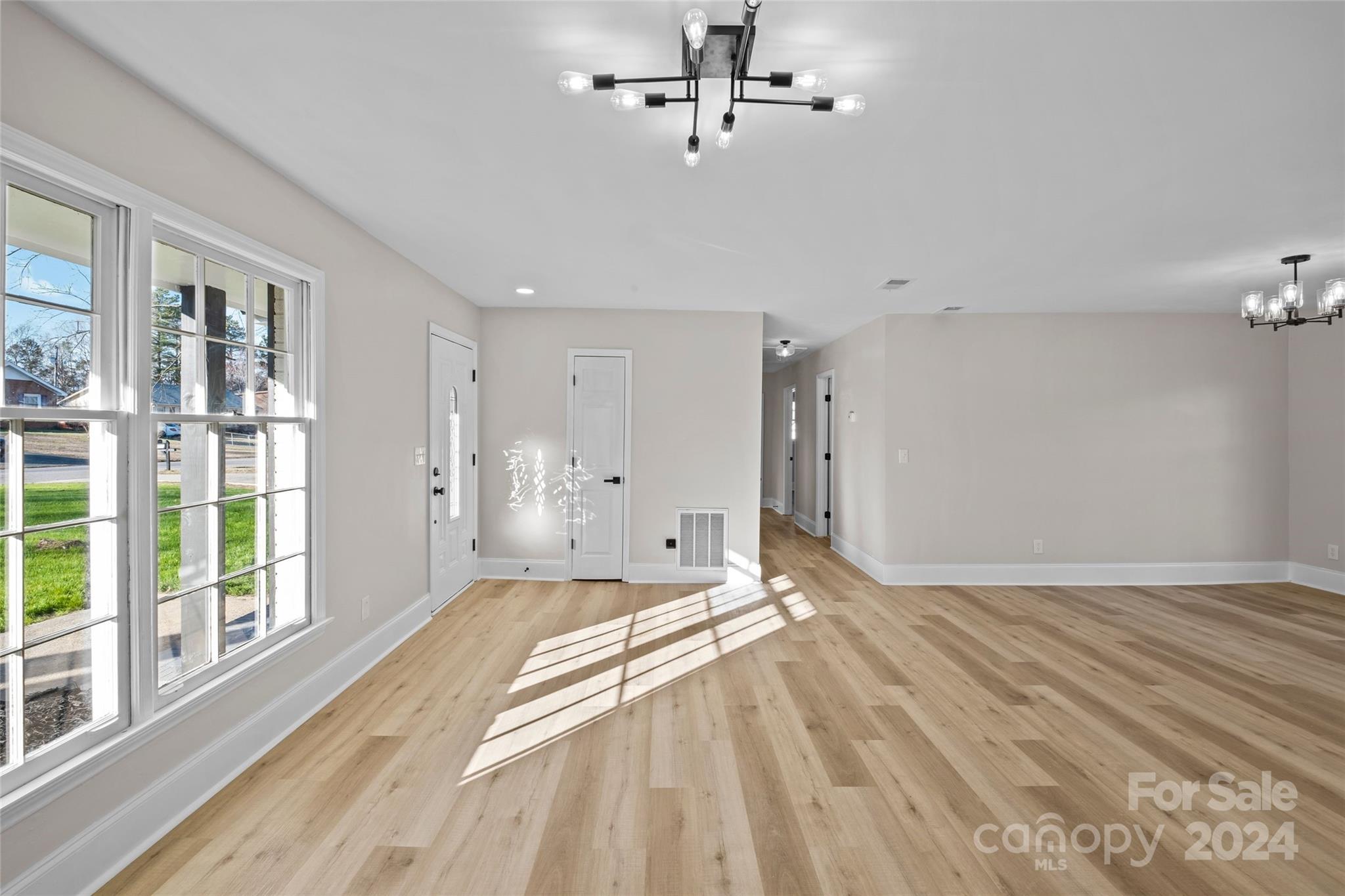 5808 Woody Grove Road Indian Trail, NC 28079 - Photo 6 of 30 a view of empty room with wooden floor and fan