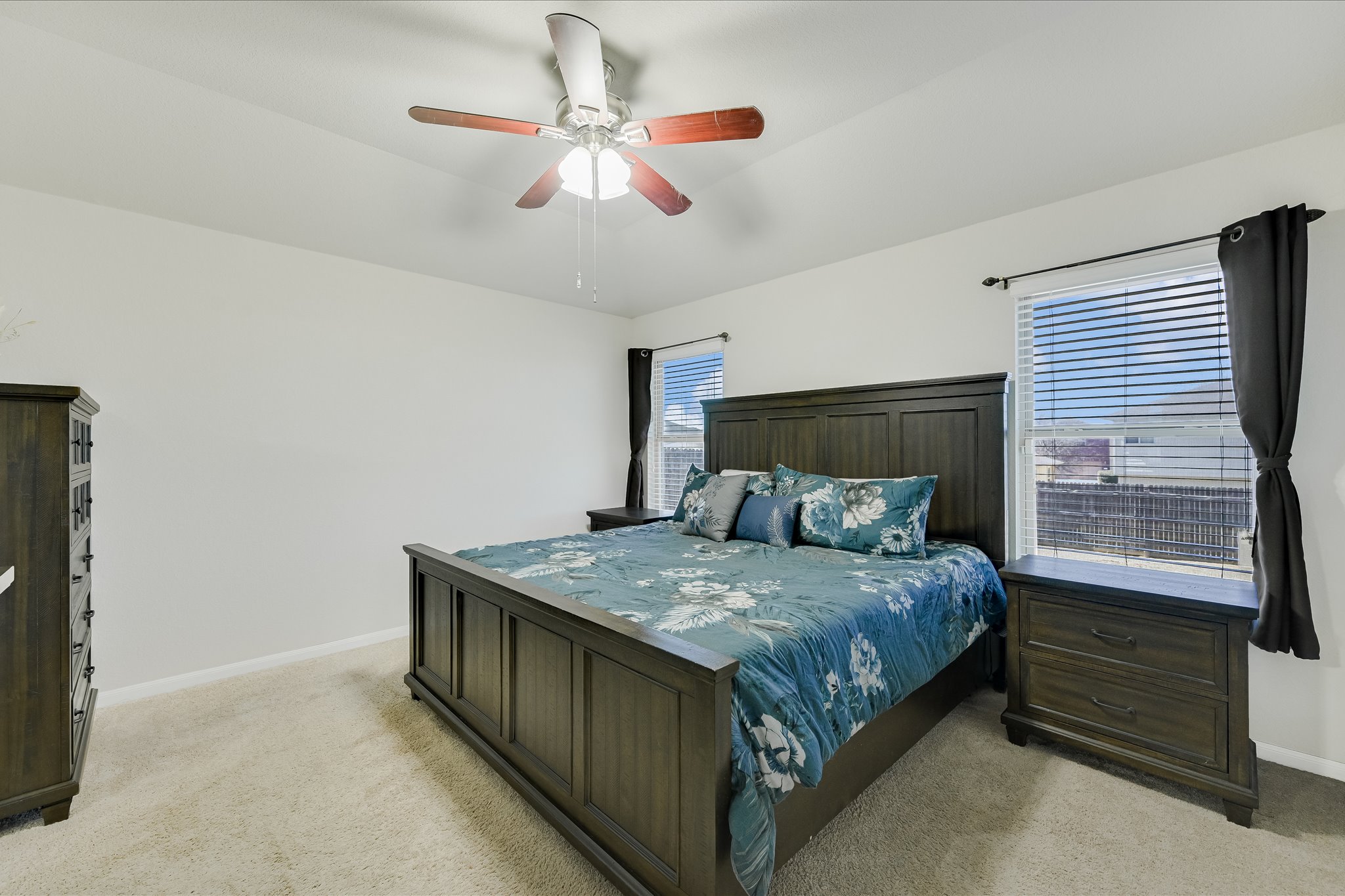 725 Pinnacle Drive Georgetown, TX 78626 - Photo 10 of 20 a bedroom with a bed and a chandelier