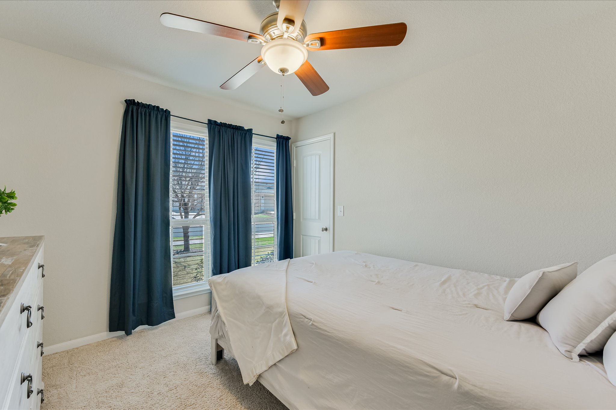 725 Pinnacle Drive Georgetown, TX 78626 - Photo 13 of 20 a bedroom with a large bed and a ceiling fan