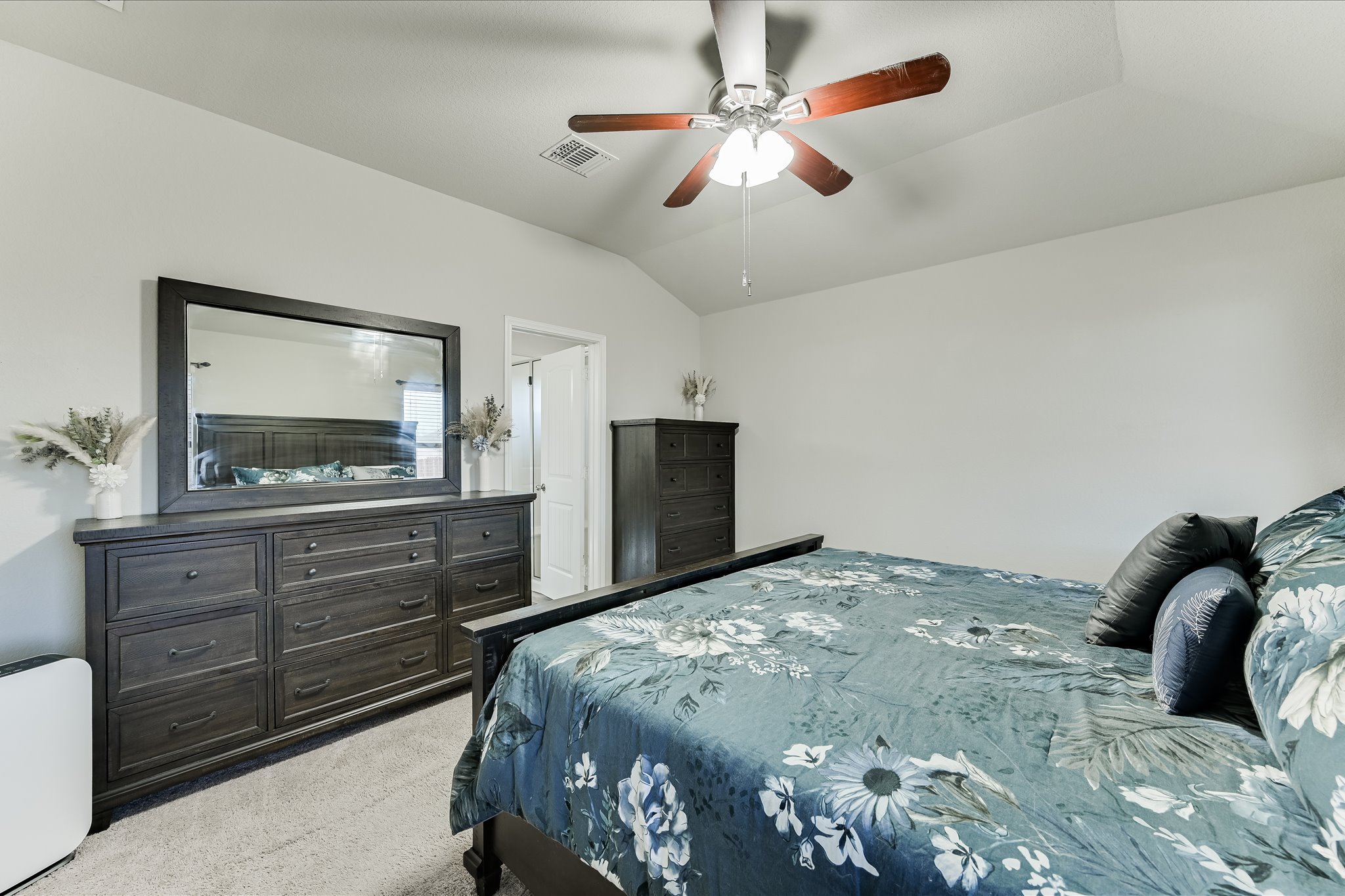 725 Pinnacle Drive Georgetown, TX 78626 - Photo 9 of 20 a bedroom with a bed and a mirror on the dresser