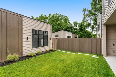 a view of kitchen with cabinets and window