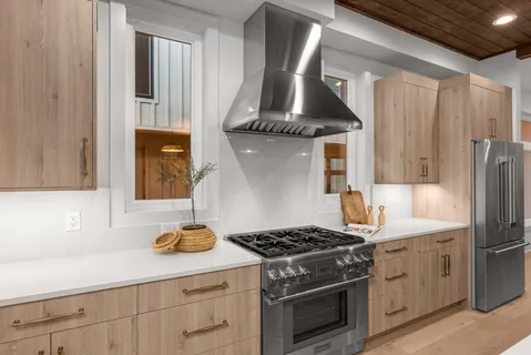 a kitchen with stainless steel appliances a sink stove and cabinets