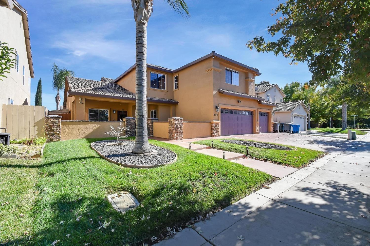 1180 Sanborn Road Yuba City, CA 95993 - Photo 2 of 26 a front view of a house with garden
