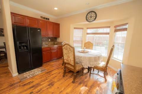 1180 Sanborn Road Yuba City, CA 95993 - Photo 5 of 26 a kitchen with stainless steel appliances granite countertop a refrigerator a stove a dining table and chairs with wooden floor