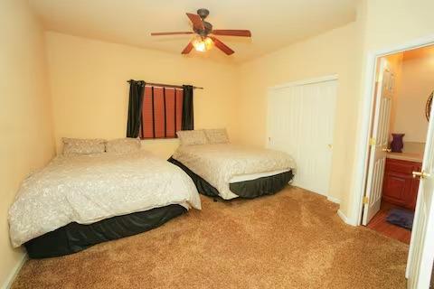 1180 Sanborn Road Yuba City, CA 95993 - Photo 9 of 26 a bedroom with a bed and a chandelier