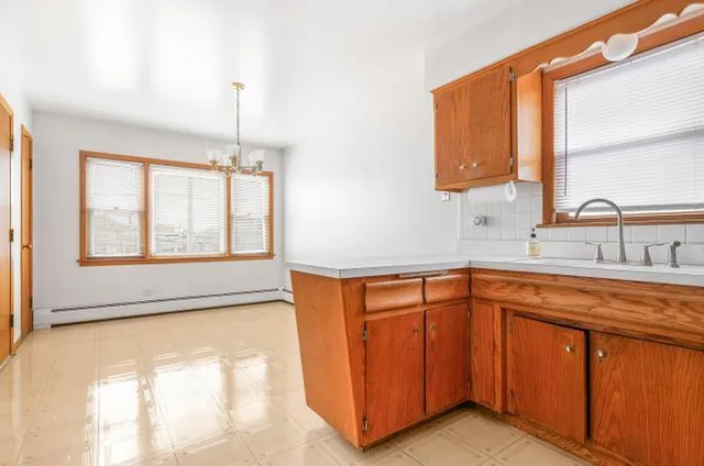 a kitchen with stainless steel appliances granite countertop a sink and a window