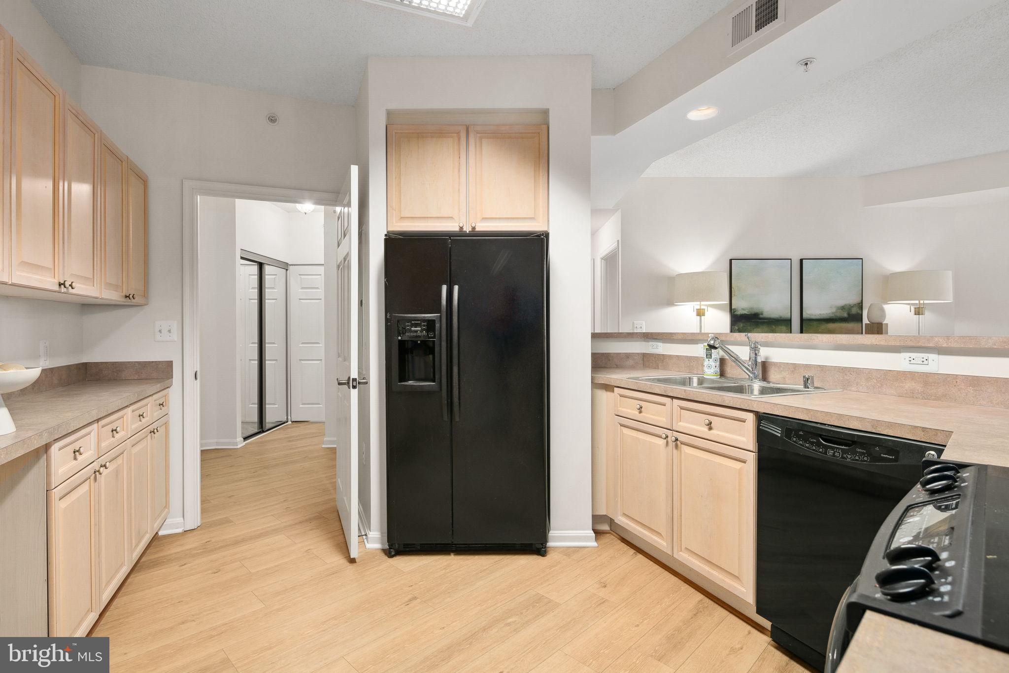19355 Cypress Ridge Terrace, Unit 803 Leesburg, VA 20176 - Photo 15 of 38 a kitchen with granite countertop a refrigerator stove and sink