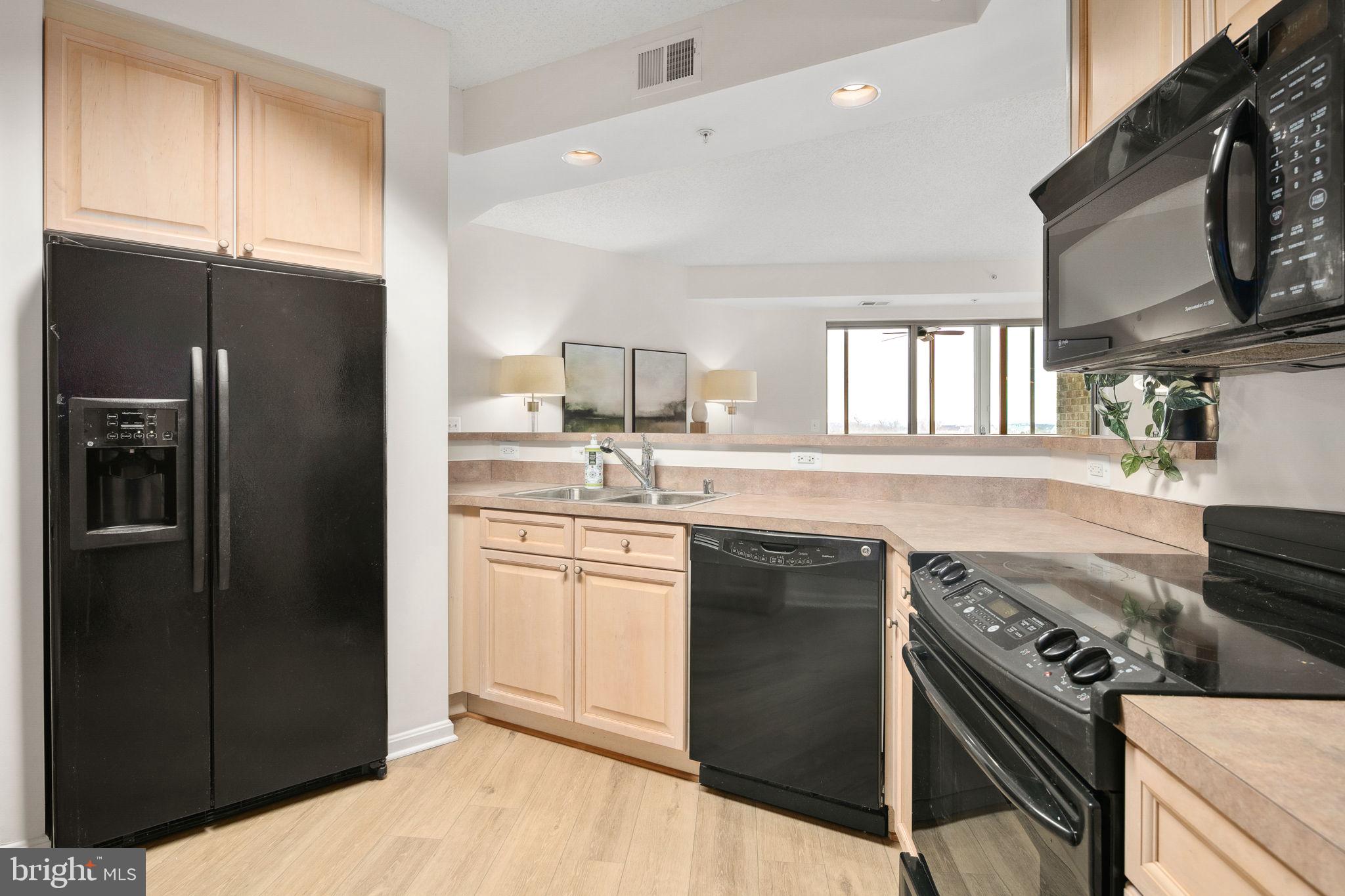 19355 Cypress Ridge Terrace, Unit 803 Leesburg, VA 20176 - Photo 16 of 38 a kitchen with a sink stove and refrigerator