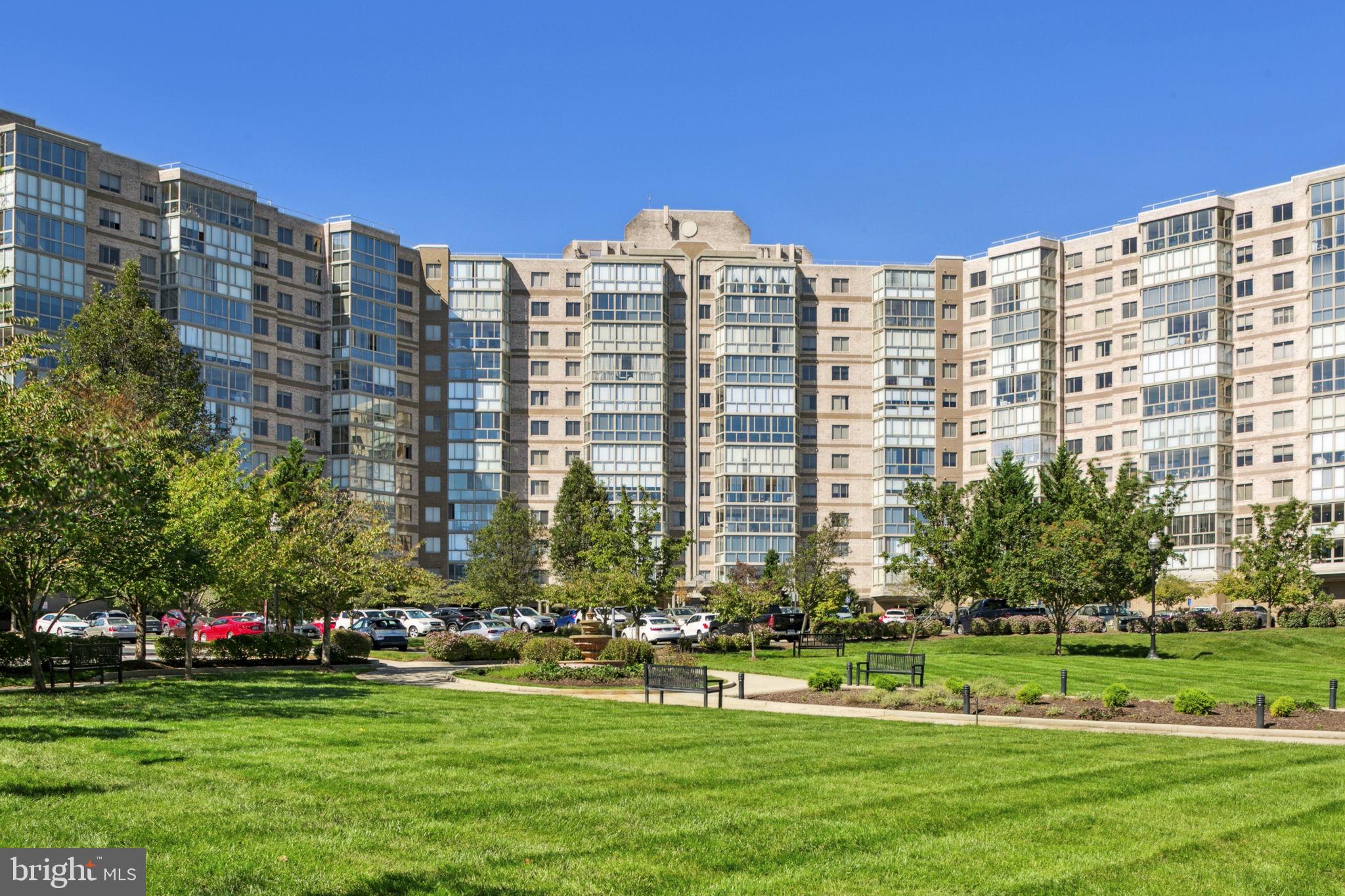 19355 Cypress Ridge Terrace, Unit 803 Leesburg, VA 20176 - Photo 33 of 38 a front view of multi story residential apartment building with play trees and yard in front of it