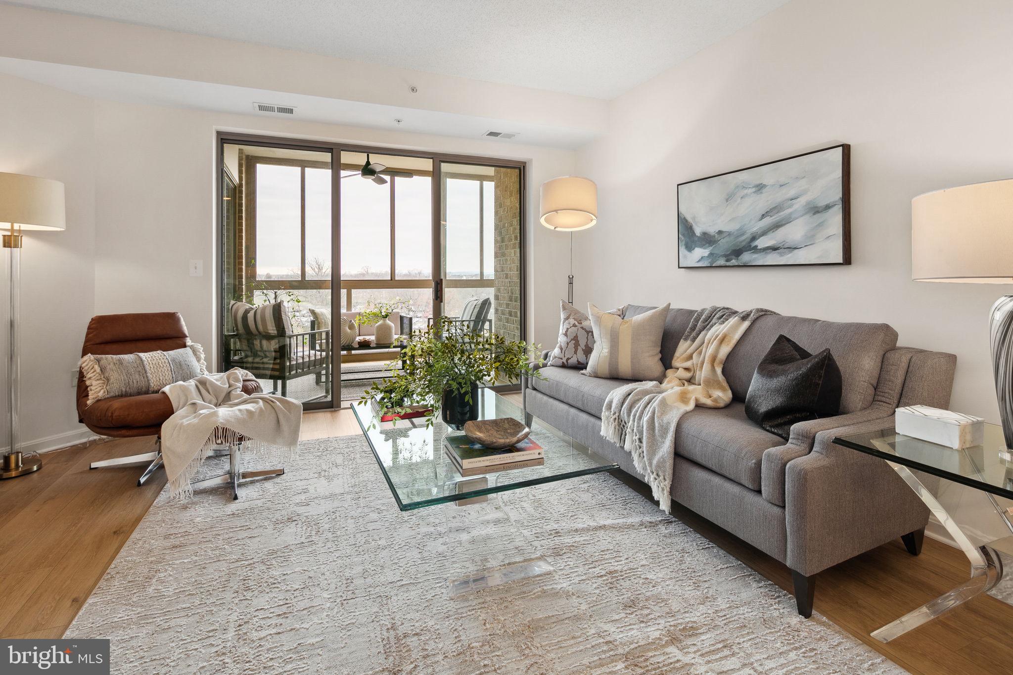 19355 Cypress Ridge Terrace, Unit 803 Leesburg, VA 20176 - Photo 5 of 38 a living room with furniture and a large window