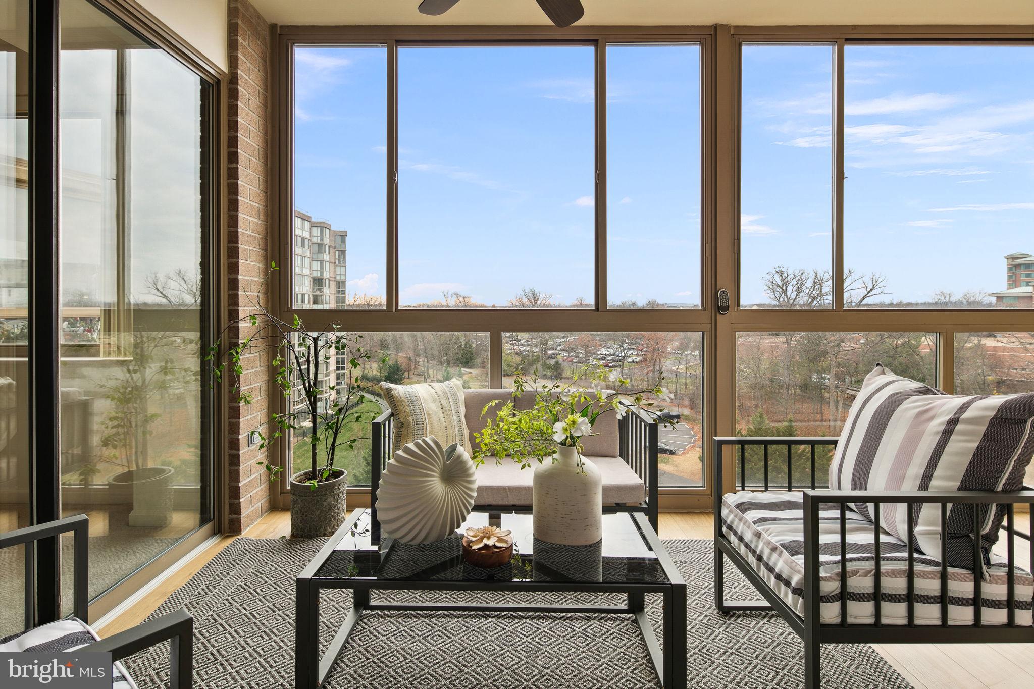 19355 Cypress Ridge Terrace, Unit 803 Leesburg, VA 20176 - Photo 6 of 38 a view of a balcony with chairs and with wooden floor