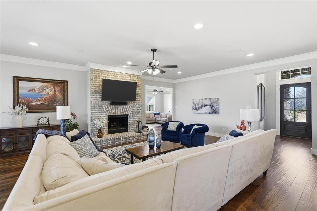640 Maggie Trail Lucas, TX 75002 - Photo 11 of 40 a living room with furniture a fireplace and a flat screen tv