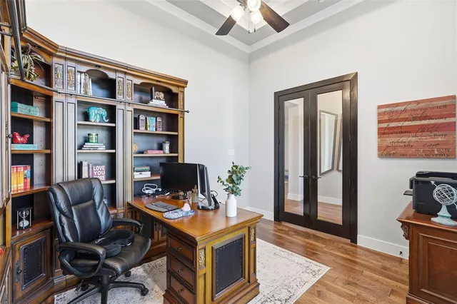 a view of a workspace with furniture and a bookshelf
