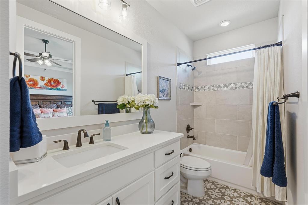640 Maggie Trail Lucas, TX 75002 - Photo 24 of 40 a bathroom with a sink a toilet and shower curtain