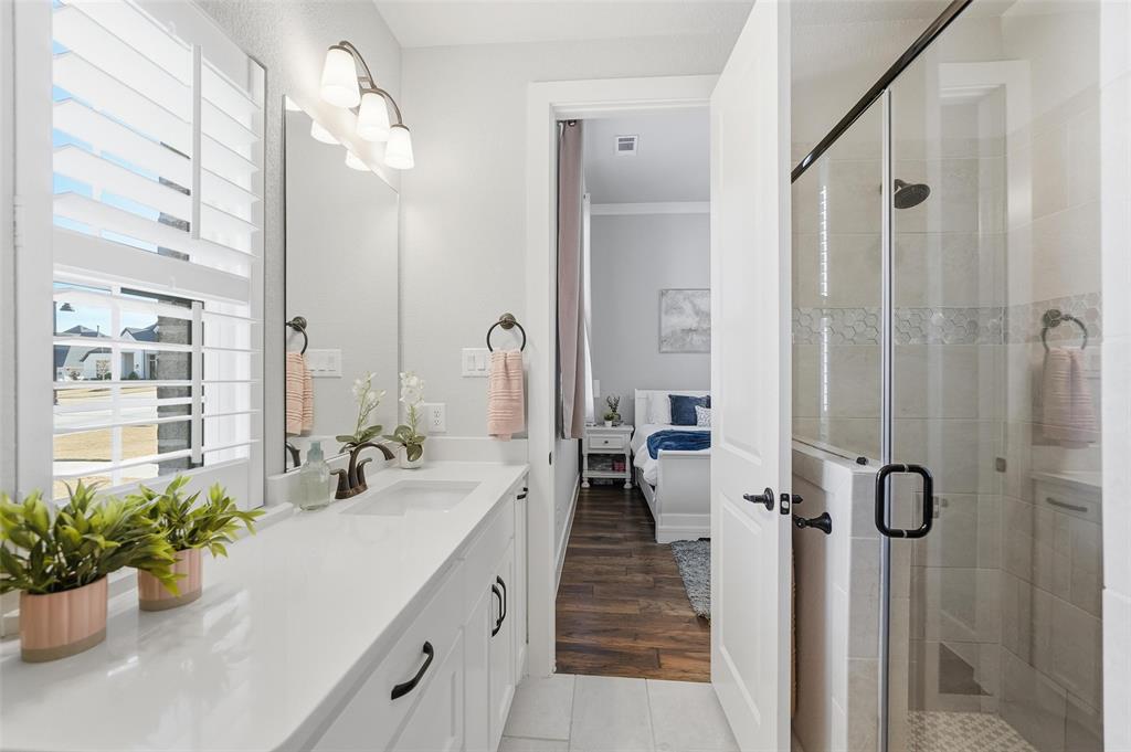 640 Maggie Trail Lucas, TX 75002 - Photo 26 of 40 a spacious bathroom with a shower sink and mirror