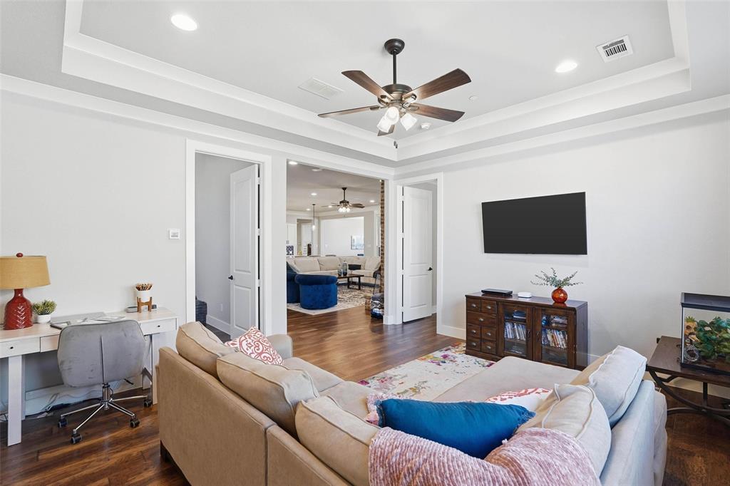 640 Maggie Trail Lucas, TX 75002 - Photo 28 of 40 a living room with furniture and a flat screen tv