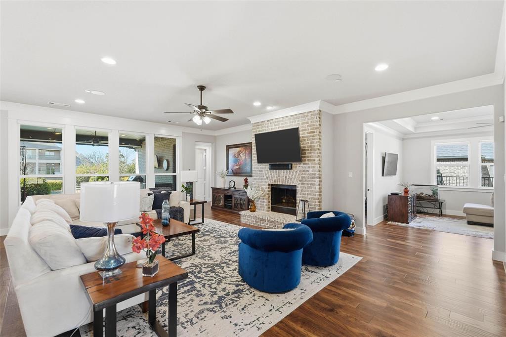 640 Maggie Trail Lucas, TX 75002 - Photo 3 of 40 a living room with furniture a fireplace and a flat screen tv