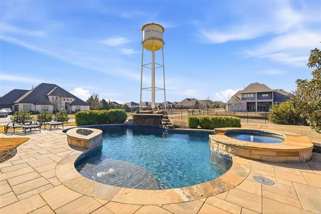 a view of a swimming pool with lounge chairs