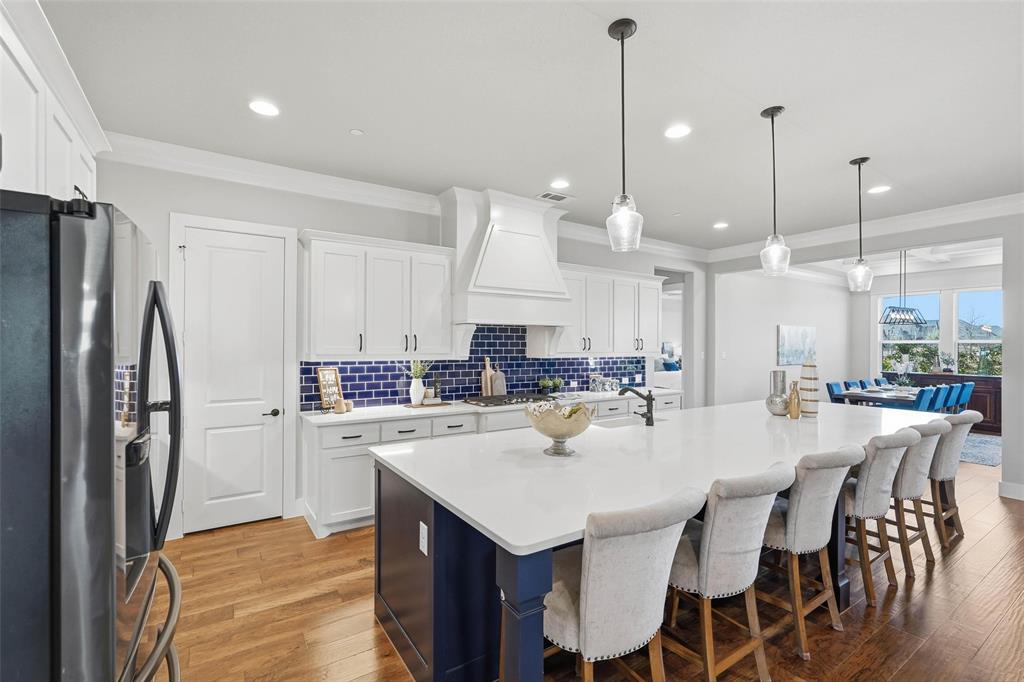 640 Maggie Trail Lucas, TX 75002 - Photo 4 of 40 a kitchen with a dining table chairs sink refrigerator and microwave