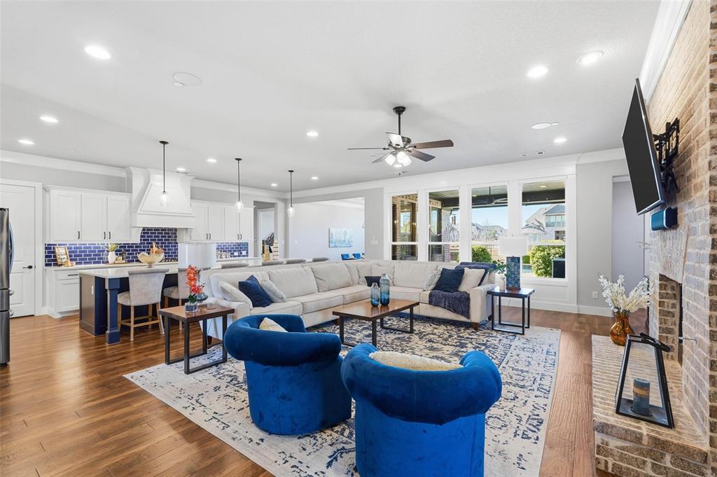 640 Maggie Trail Lucas, TX 75002 - Photo 5 of 40 a living room with furniture kitchen view and a flat screen tv