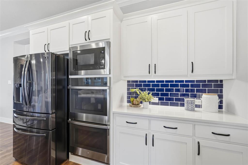 640 Maggie Trail Lucas, TX 75002 - Photo 9 of 40 a kitchen with refrigerator and cabinets