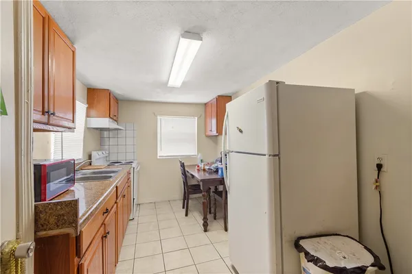 a kitchen with a sink appliances and cabinets