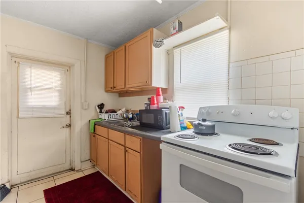 a kitchen with a sink stove and cabinets