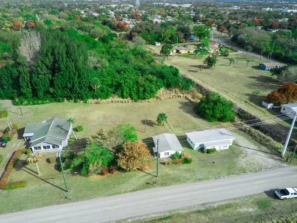 an aerial view of multiple houses with yard