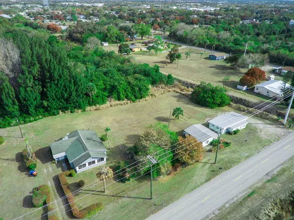 an aerial view of multiple houses with yard